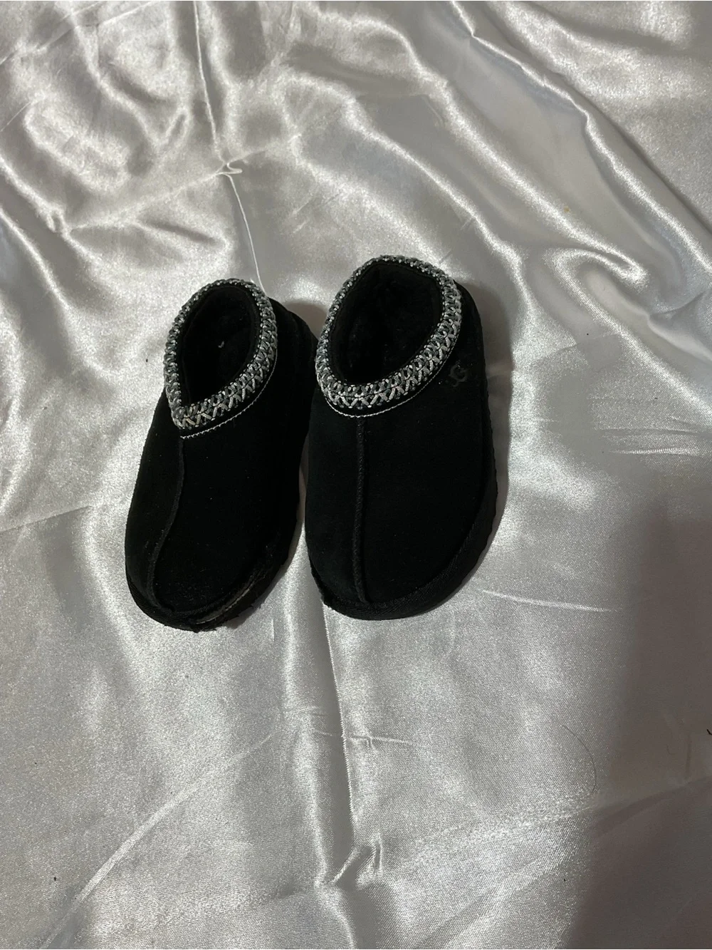 Kids Black Cozy Slip-On Shoes with Decorative Trim It is torn to shreds—heaps of